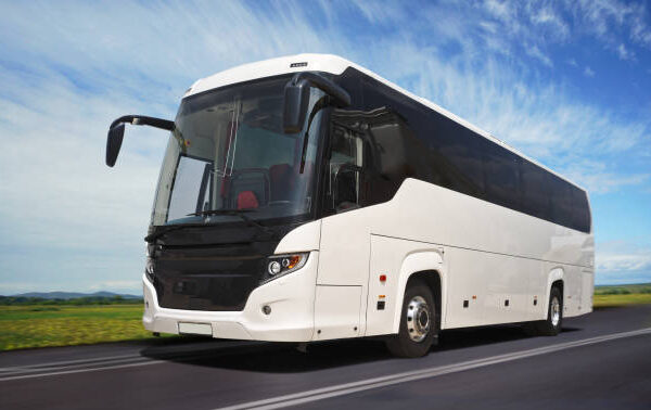 White coach bus on a highway.